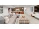 Cozy finished basement with a large sectional sofa, kitchenette and bright recessed lighting at 4590 Wolff St, Denver, CO 80212