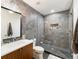 Modern bathroom features decorative tiling, glass enclosed shower, contemporary lighting and sink at 4590 Wolff St, Denver, CO 80212