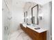 Elegant bathroom features double sink vanity with modern mirrors and a glass walk-in shower at 4590 Wolff St, Denver, CO 80212