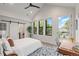 Bright bedroom with high ceilings, large windows, and a sliding barn door to closet and balcony access at 4590 Wolff St, Denver, CO 80212