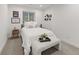 Neutral bedroom featuring a comfortable bed with a bench at the foot and a lovely bedside table at 4590 Wolff St, Denver, CO 80212