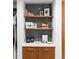 Custom closet featuring stylish hexagon tile backsplash, wooden cabinets, and open shelving at 4590 Wolff St, Denver, CO 80212