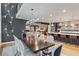Open-concept floor plan with a dark wood table, white upholstered chairs and luxury vinyl plank flooring at 4590 Wolff St, Denver, CO 80212