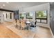 Inviting dining room with a large table, comfortable seating and views of the outdoors through bright windows at 4590 Wolff St, Denver, CO 80212