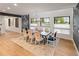 Dining room with wood floors, long table with 8 chairs, chandelier and windows with an exterior view at 4590 Wolff St, Denver, CO 80212