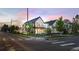 Attractive two-story house with black metal roof sits on a corner with street views and inviting landscaping at 4590 Wolff St, Denver, CO 80212