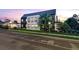 Modern home with white brick, black trim, a black metal roof and lush landscaping along a city street at 4590 Wolff St, Denver, CO 80212