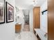 Bright hallway with marble floors, built-in storage bench, and elegant access to the walk-in closet at 4590 Wolff St, Denver, CO 80212
