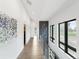 Bright hallway with hardwood floors, modern lighting, and large windows overlooking the neighborhood at 4590 Wolff St, Denver, CO 80212