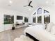 Sun-filled main bedroom boasting vaulted ceilings, many windows, ceiling fan and a wall-mounted TV at 4590 Wolff St, Denver, CO 80212