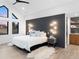 Beautiful main bedroom featuring a statement wall, light hardwood floors, and a private closet at 4590 Wolff St, Denver, CO 80212