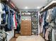 Spacious walk-in closet featuring dark wood shelving, drawers and rods for clothing storage at 4590 Wolff St, Denver, CO 80212