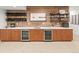 Close up on basement kitchenette with custom wood backsplash, wine racks, and beverage refrigerators at 4590 Wolff St, Denver, CO 80212