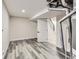 Unfinished basement area featuring light gray LVP flooring and access to a stairway at 3082 S Florence Ct, Denver, CO 80231