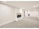 Spacious basement featuring a cozy fireplace, plush carpeting, and ample room for entertainment or relaxation at 3082 S Florence Ct, Denver, CO 80231