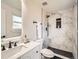 Modern bathroom showcasing a sleek vanity, marble-tiled shower, and matte black fixtures for a luxurious feel at 3082 S Florence Ct, Denver, CO 80231