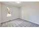 Bright bedroom featuring gray carpet, neutral walls, a window and white trim throughout at 3082 S Florence Ct, Denver, CO 80231