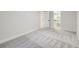 Bedroom featuring gray carpet, neutral walls, white trim and access to a closet at 3082 S Florence Ct, Denver, CO 80231