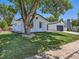 Lovely brick home with mature tree and well-maintained lawn at 3082 S Florence Ct, Denver, CO 80231