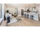 Open-concept kitchen and living room with hardwood floors and neutral decor at 3082 S Florence Ct, Denver, CO 80231