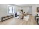 Bright living room with light hardwood floors and large bay window with seating at 3082 S Florence Ct, Denver, CO 80231