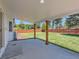 Covered patio area overlooking a spacious backyard with a well-maintained lawn and wood fence at 3082 S Florence Ct, Denver, CO 80231