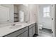 Modern bathroom featuring double sinks with quartz countertops and gray cabinets at 1341 Loraine N Cir, Lafayette, CO 80026