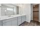Bathroom with double vanity, modern fixtures, and a view into the walk-in closet and shower at 1341 Loraine N Cir, Lafayette, CO 80026