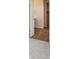 Hallway with view of vanity and linen closet with carpet in the bedroom beyond at 1341 Loraine N Cir, Lafayette, CO 80026
