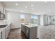 Kitchen features gray cabinets, stainless steel appliances, a large island, and sliding doors to the outside at 1341 Loraine N Cir, Lafayette, CO 80026