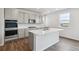 Bright kitchen showcases gray cabinets, stainless steel appliances, quartz countertops, and a large island at 1341 Loraine N Cir, Lafayette, CO 80026