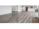 Open-concept living area with durable wood-look flooring that flows seamlessly into the kitchen at 1341 Loraine N Cir, Lafayette, CO 80026