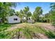 A spacious backyard features a detached garage and storage shed, with a grassy area under mature trees at 2571 S Birch St, Denver, CO 80222