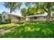 Expansive backyard featuring a well-maintained lawn, mature trees and a detached garage at 2571 S Birch St, Denver, CO 80222
