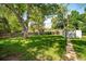 Lush backyard with expansive green space, mature trees, storage shed and wooden fence at 2571 S Birch St, Denver, CO 80222