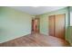 Well-lit bedroom with original hardwood floors and a closet, providing ample space at 2571 S Birch St, Denver, CO 80222
