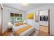 A well lit bedroom with a queen bed, and closet adjacent to the main room at 2571 S Birch St, Denver, CO 80222