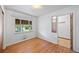 A sunlit bedroom with hardwood floors and closet adjacent to the main room at 2571 S Birch St, Denver, CO 80222