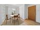Cozy dining area with room for four, featuring natural light, hardwood floors, and built-in shelving at 2571 S Birch St, Denver, CO 80222