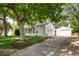 Charming home with a well-maintained lawn, mature trees, and a detached one car garage at 2571 S Birch St, Denver, CO 80222