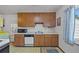 Efficient kitchen featuring wood cabinets, white countertops, a microwave, and a dishwasher at 2571 S Birch St, Denver, CO 80222