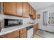 Functional kitchen with wood cabinets, white countertops, and essential appliances at 2571 S Birch St, Denver, CO 80222