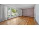 Spacious living room with hardwood floors, large windows, and a unique brick accent wall at 2571 S Birch St, Denver, CO 80222
