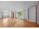 Bright living room featuring hardwood floors, large windows, a brick accent wall, and built-in shelving at 2571 S Birch St, Denver, CO 80222