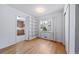 Versatile room featuring hardwood floors, white walls, a window, and access to the kitchen at 2571 S Birch St, Denver, CO 80222