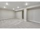Expansive finished basement featuring neutral walls, plush carpeting, and access to the stairway at 1443 Great Western Dr, Longmont, CO 80501