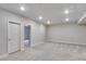Large finished basement showcasing neutral walls, carpeted floors, and multiple doors at 1443 Great Western Dr, Longmont, CO 80501