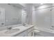 Modern bathroom featuring double sinks, white subway tile, and a shower-tub combination at 1443 Great Western Dr, Longmont, CO 80501