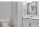 Powder room features modern vanity with white cabinets, sink and fixtures, and toilet at 1443 Great Western Dr, Longmont, CO 80501