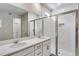 Elegant bathroom with double vanity, white cabinets, and glass-enclosed shower with tile at 1443 Great Western Dr, Longmont, CO 80501